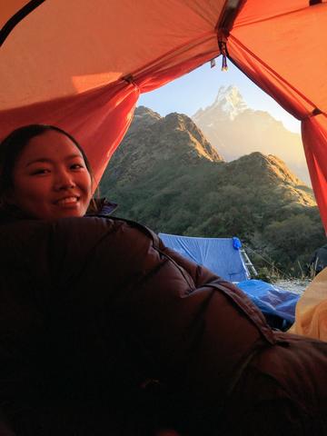 Tsechu in a tent with mountain in the background